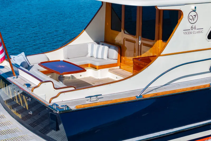 Holly Ann Yacht Photos Pics 2010 Vicem 64 Classic yacht with elegant seating and wooden accents on a sunny day.