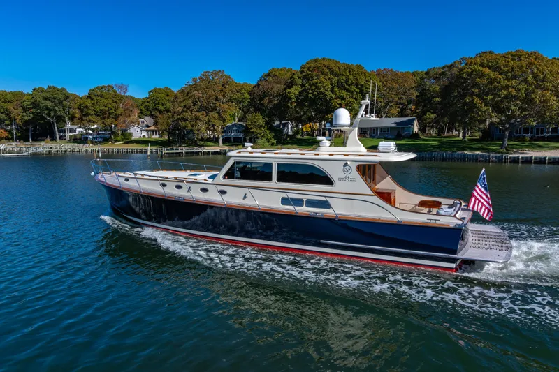 Holly Ann Yacht Photos Pics 2010 Vicem 64 Classic yacht cruising on a serene lake with lush greenery.