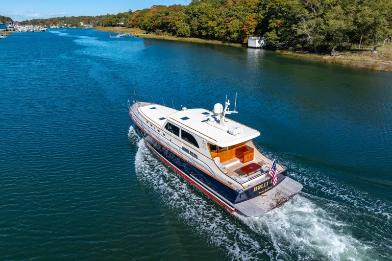 Holly Ann Yacht Photos Pics 2010 Vicem 64 Classic yacht cruising on a scenic river with lush green surroundings.
