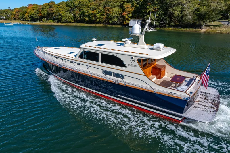 Holly Ann Yacht Photos Pics 2010 Vicem 64 Classic yacht cruising on a serene lake with lush green surroundings.