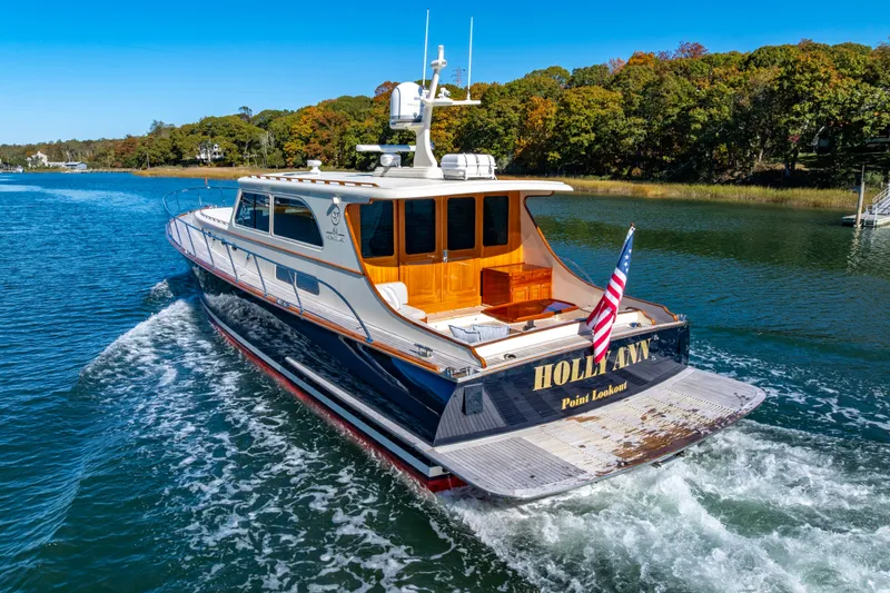 Holly Ann Yacht Photos Pics 2010 Vicem 64 Classic yacht cruising on a scenic waterway with lush greenery.