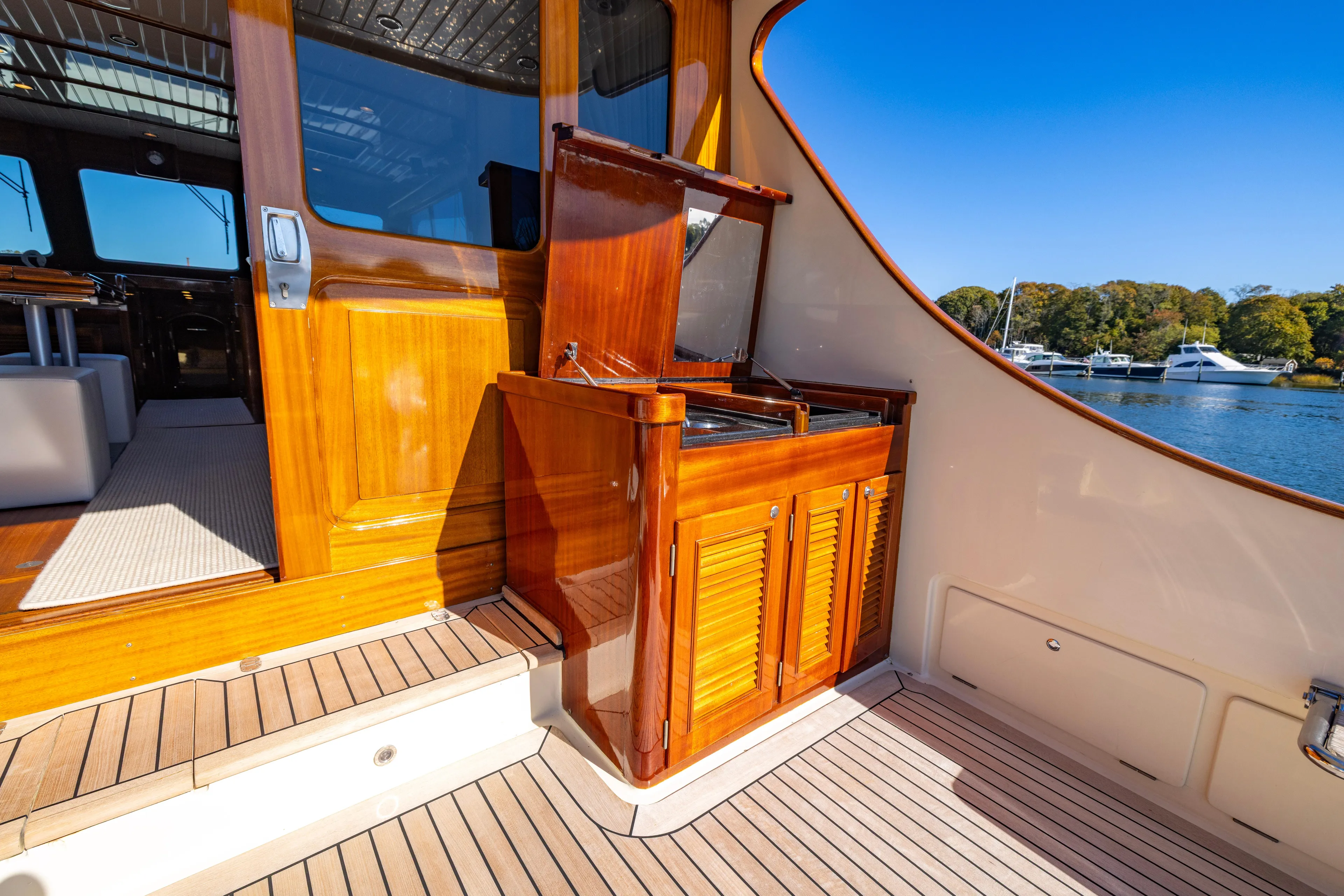 Holly Ann Yacht Photos Pics Luxurious 2010 Vicem 64 Classic yacht interior with polished wood finish and scenic water view.