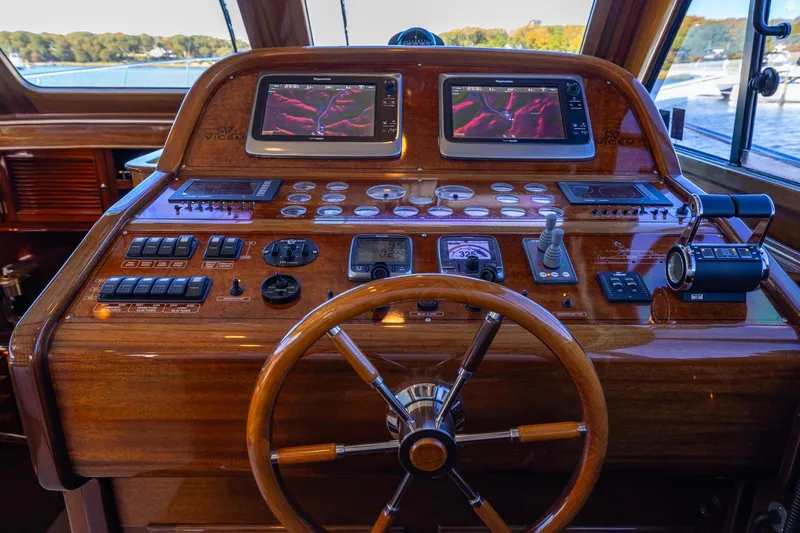 Holly Ann Yacht Photos Pics Cockpit of 2010 Vicem 64 Classic yacht with wooden steering wheel and navigation controls.