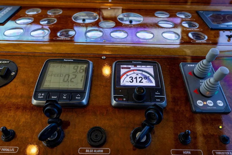 Holly Ann Yacht Photos Pics Control panel of 2010 Vicem 64 Classic yacht with navigation instruments and joysticks.