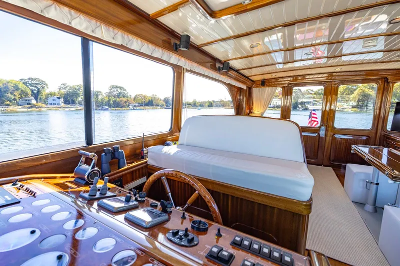 Holly Ann Yacht Photos Pics Luxurious interior of 2010 Vicem 64 Classic yacht with wooden finishes and scenic water views.