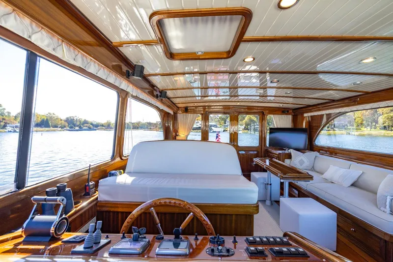Holly Ann Yacht Photos Pics Luxurious interior of 2010 Vicem 64 Classic yacht with wooden finishes and scenic water views.