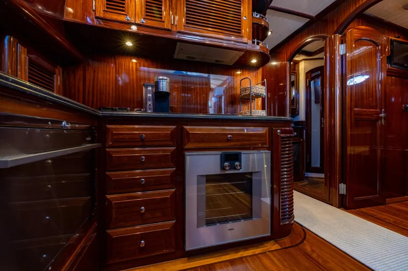 Holly Ann Yacht Photos Pics Luxurious wooden interior of 2010 Vicem 64 Classic yacht kitchen with modern appliances.