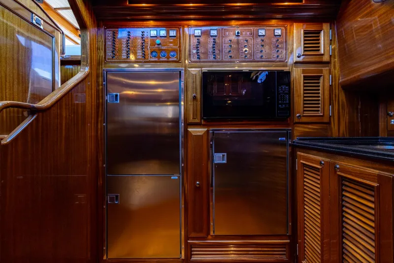 Holly Ann Yacht Photos Pics Luxurious wooden interior of 2010 Vicem 64 Classic yacht kitchen with modern appliances.