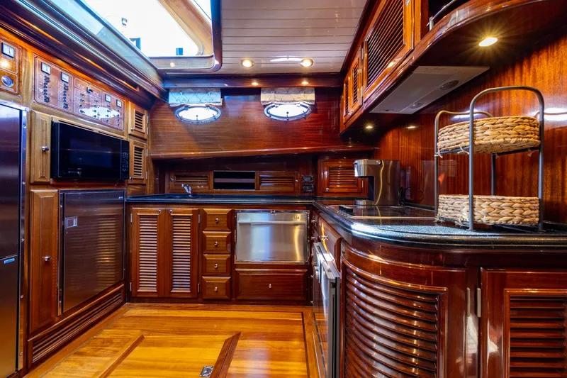 Holly Ann Yacht Photos Pics Luxurious 2010 Vicem 64 Classic yacht kitchen with rich wood cabinetry and modern appliances.