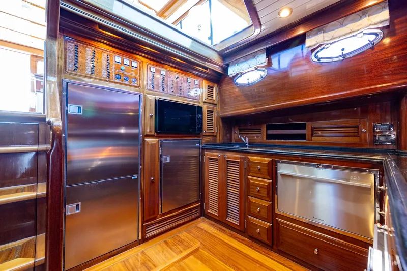 Holly Ann Yacht Photos Pics Luxurious 2010 Vicem 64 Classic yacht kitchen with wood cabinetry and stainless steel appliances.