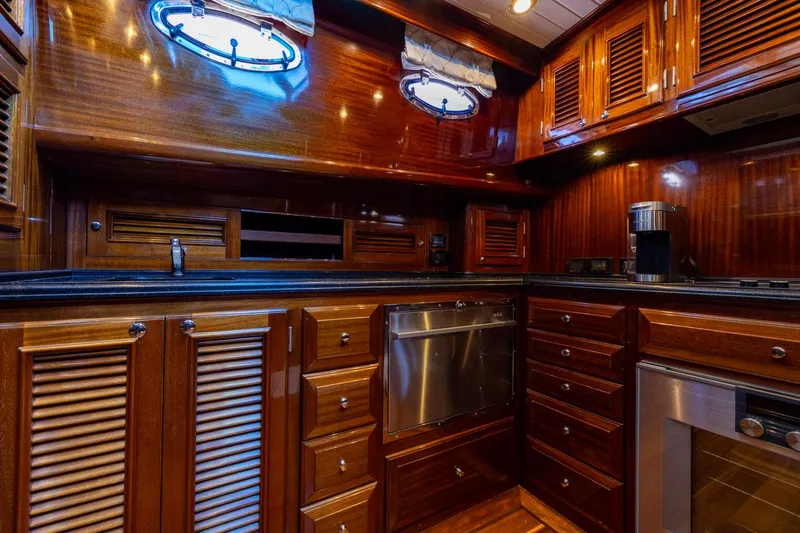 Holly Ann Yacht Photos Pics Luxurious wooden interior of 2010 Vicem 64 Classic yacht kitchen with modern appliances.