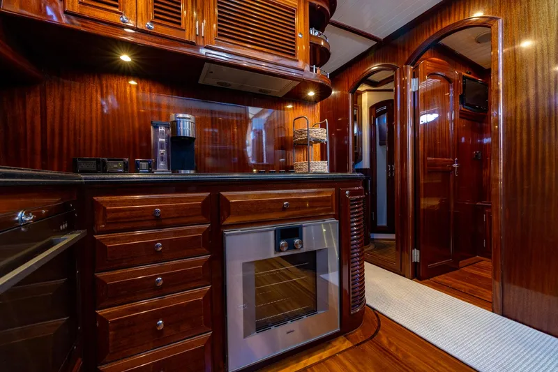 Holly Ann Yacht Photos Pics Luxurious wooden interior of 2010 Vicem 64 Classic yacht kitchen with modern appliances.