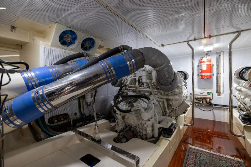 Holly Ann Yacht Photos Pics Engine room of 2010 Vicem 64 Classic yacht with visible machinery and fire extinguisher.