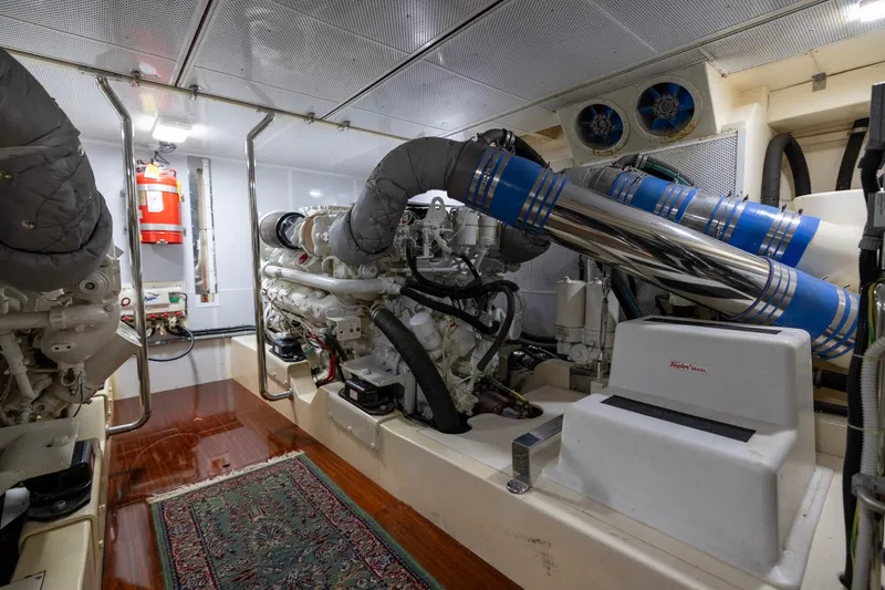 Holly Ann Yacht Photos Pics Engine room of 2010 Vicem 64 Classic yacht, featuring dual engines and polished metal pipes.