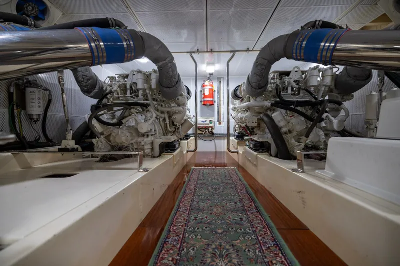 Holly Ann Yacht Photos Pics Engine room of 2010 Vicem 64 Classic yacht, featuring dual engines and a fire extinguisher.