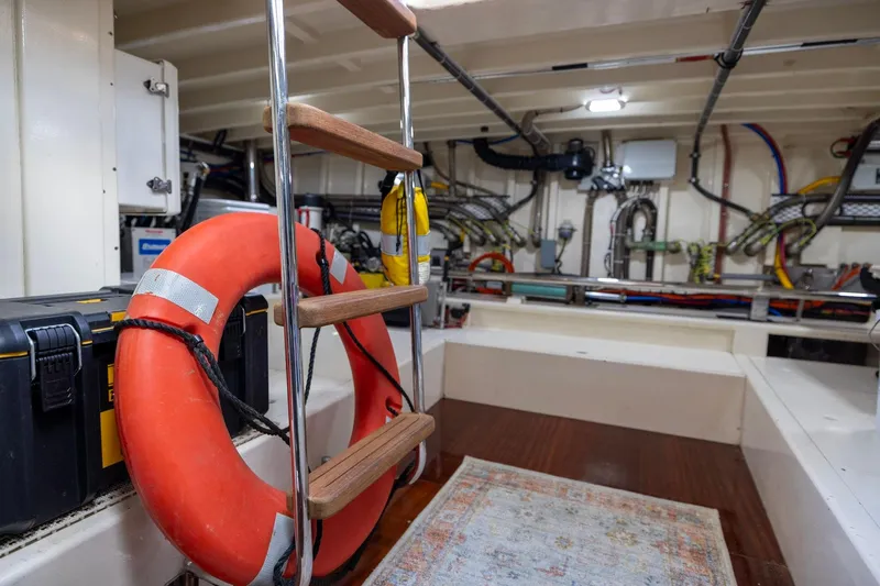 Holly Ann Yacht Photos Pics Engine room of 2010 Vicem 64 Classic yacht with ladder, life preserver, and equipment.