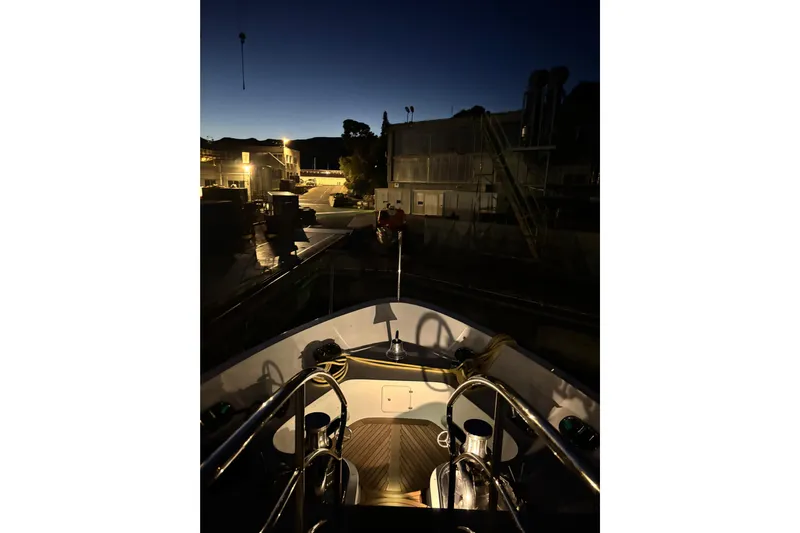  Yacht Photos Pics Night view from the deck of a 2015 Benetti 121 yacht in a marina.