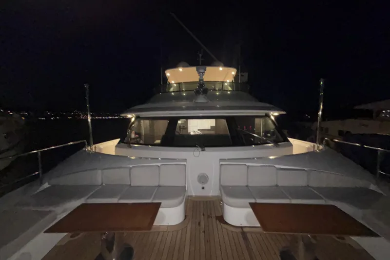  Yacht Photos Pics Luxurious 2015 Benetti 121 yacht deck at night, featuring elegant seating and tables.