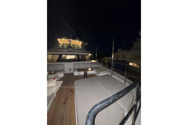  Yacht Photos Pics Luxurious 2015 Benetti 121 yacht deck at night, featuring elegant seating and lighting.