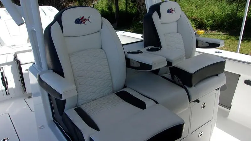  Yacht Photos Pics 2022 Crevalle 33 CSF Offshore Fishing boat seats, featuring plush white and black upholstery.