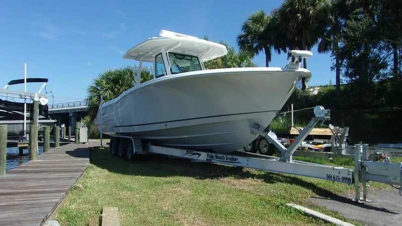  Yacht Photos Pics 2022 Crevalle 33 CSF Offshore Fishing boat on trailer by dock.
