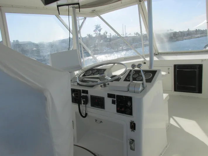 My Way IV Yacht Photos Pics 1987 Hatteras Convertible yacht helm with steering wheel and control panels.