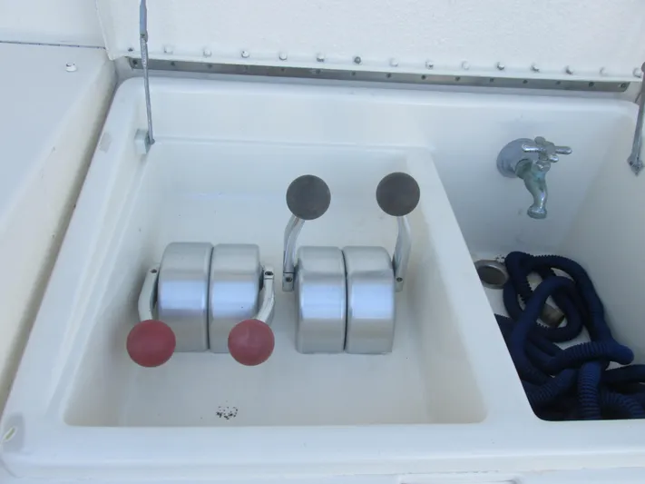 My Way IV Yacht Photos Pics 1987 Hatteras Convertible boat controls and faucet in a compartment.