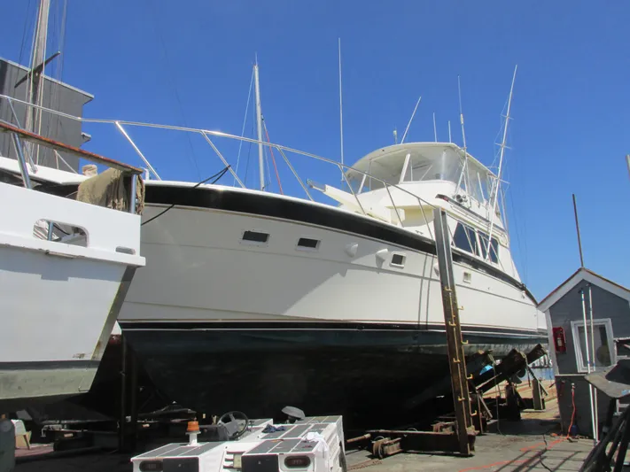 My Way IV Yacht Photos Pics 1987 Hatteras Convertible yacht on dry dock under clear blue sky.
