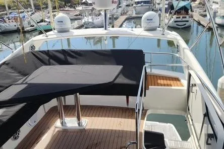  Yacht Photos Pics 2016 Jeanneau Prestige 50 yacht with covered seating area in marina.