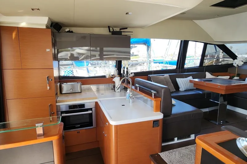 Yacht Photos Pics Luxurious interior of 2016 Jeanneau Prestige 50 yacht with modern kitchen and seating area.