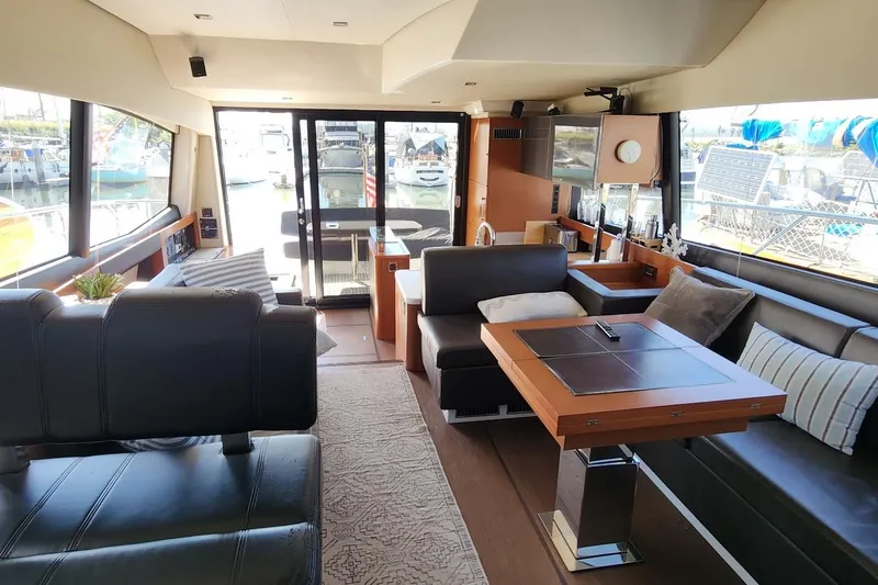  Yacht Photos Pics Luxurious interior of a 2016 Jeanneau Prestige 50 yacht, featuring elegant seating and modern decor.