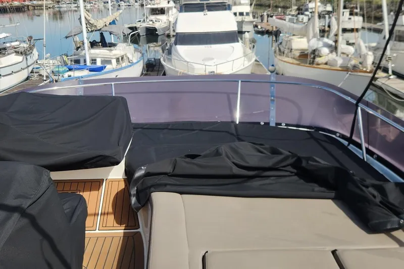  Yacht Photos Pics Jeanneau Prestige 50 yacht deck, 2016 model, docked at marina with covered seating.