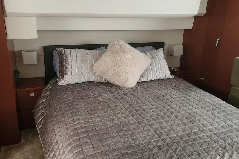  Yacht Photos Pics Luxurious bedroom interior of 2016 Jeanneau Prestige 50 yacht with plush bedding.