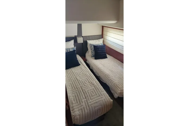  Yacht Photos Pics Twin beds in the 2016 Jeanneau Prestige 50 yacht cabin, featuring elegant bedding and decor.