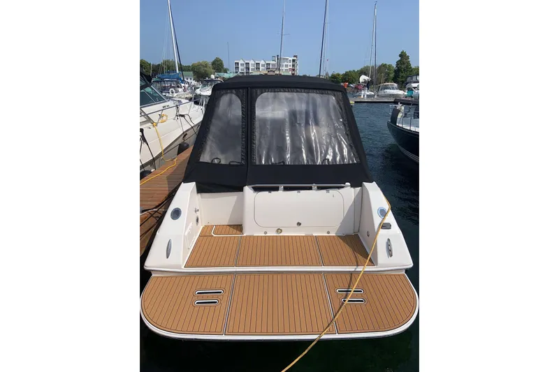  Yacht Photos Pics 2006 Fountain 38 Express Cruiser docked at marina, rear view with covered cockpit.