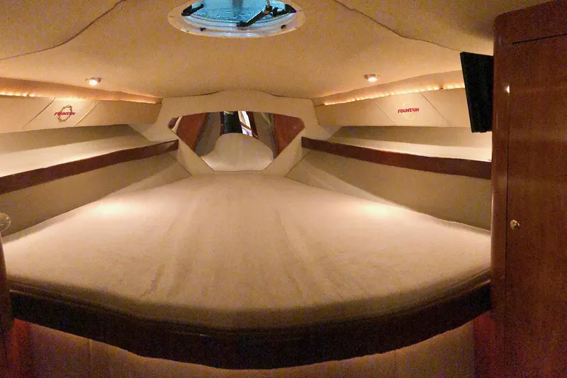  Yacht Photos Pics Interior cabin of 2006 Fountain 38 Express Cruiser, featuring cozy sleeping area and ambient lighting.