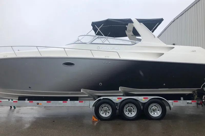  Yacht Photos Pics 2006 Fountain 38 Express Cruiser on trailer, sleek design, black and white exterior.