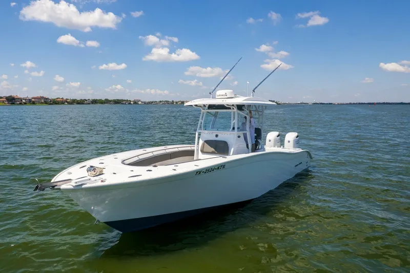  Yacht Photos Pics 2022 Cape Horn 31 T boat on calm water under a clear blue sky.