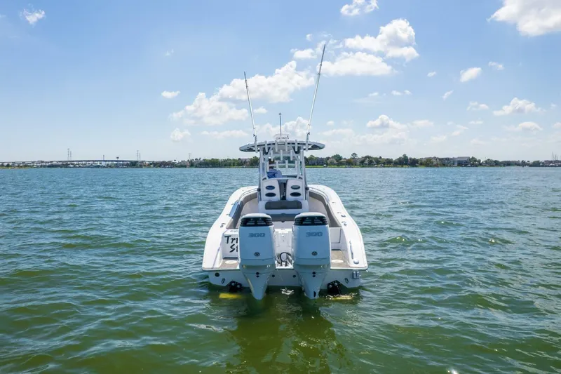  Yacht Photos Pics 2022 Cape Horn 31 T boat on water, twin engines, clear sky, distant shoreline.