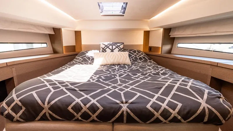  Yacht Photos Pics Luxurious bedroom interior of 2022 Prestige 460 Fly yacht with modern bedding and natural light.