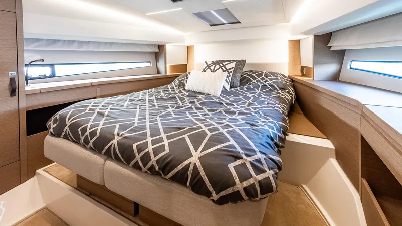  Yacht Photos Pics Luxurious bedroom interior of 2022 Prestige 460 Fly yacht with modern bedding.