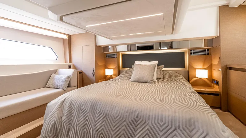  Yacht Photos Pics Luxurious bedroom interior of 2022 Prestige 460 Fly yacht with modern design and cozy lighting.
