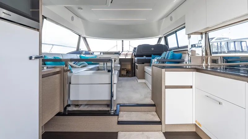  Yacht Photos Pics Luxurious interior of 2022 Prestige 460 Fly yacht with modern seating and kitchen area.