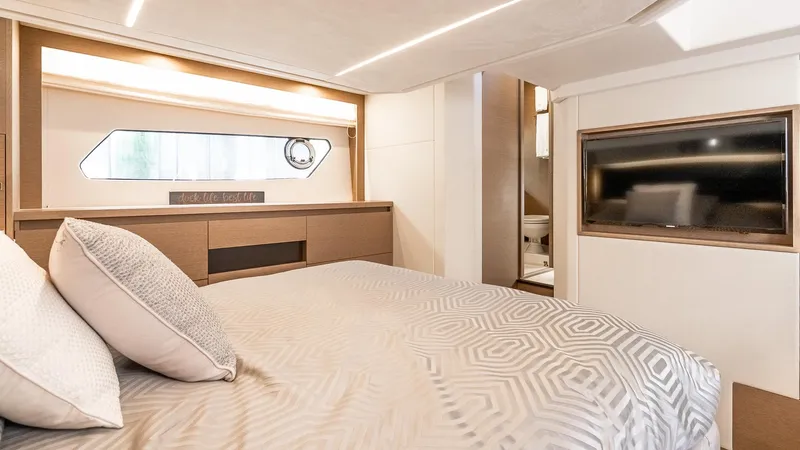  Yacht Photos Pics Luxurious bedroom interior of 2022 Prestige 460 Fly yacht with modern design and cozy bedding.