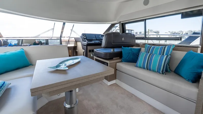  Yacht Photos Pics Interior of 2022 Prestige 460 Fly yacht with modern seating and blue cushions.