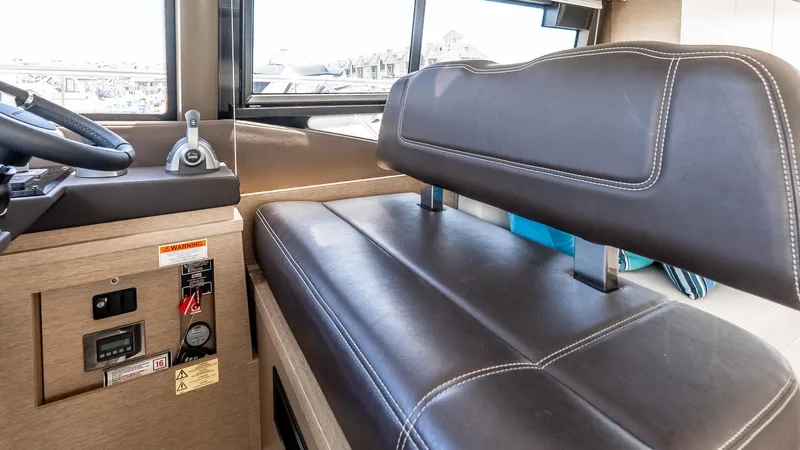  Yacht Photos Pics Interior of 2022 Prestige 460 Fly yacht with leather seating and control panel.