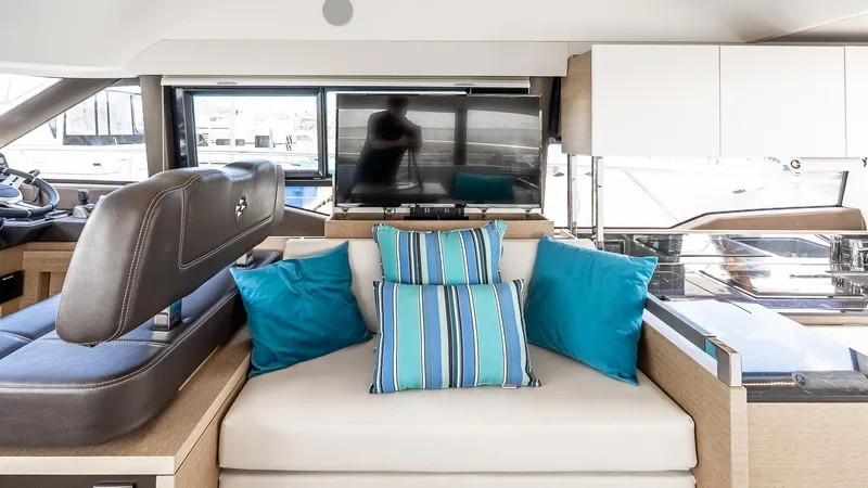  Yacht Photos Pics Interior of 2022 Prestige 460 Fly yacht with modern seating and striped cushions.