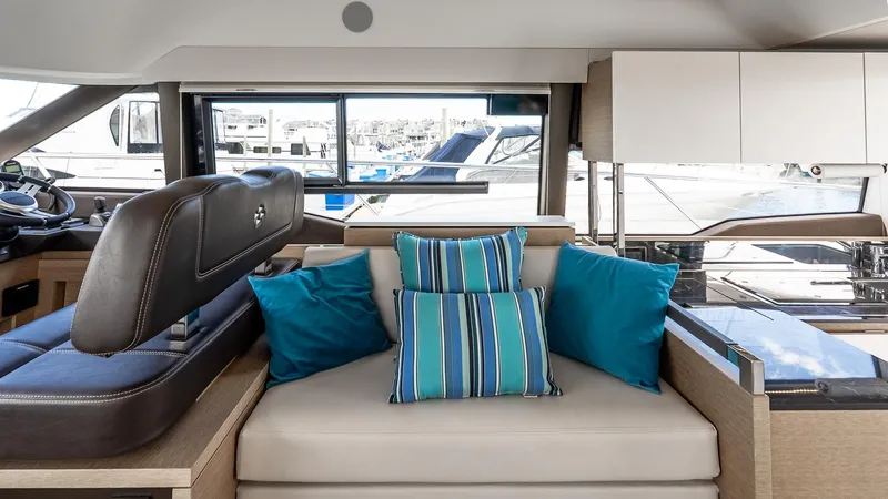 Yacht Photos Pics Interior of 2022 Prestige 460 Fly yacht with modern seating and blue accent pillows.