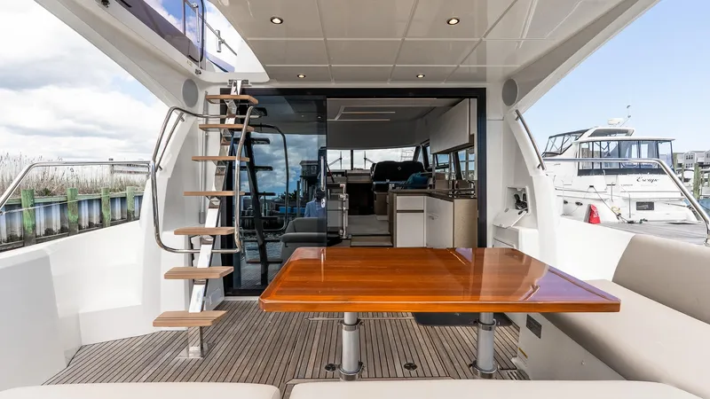  Yacht Photos Pics 2022 Prestige 460 Fly yacht interior with wooden table and modern design.