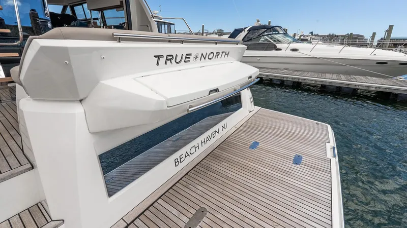  Yacht Photos Pics 2022 Prestige 460 Fly yacht docked, featuring spacious deck and elegant design.